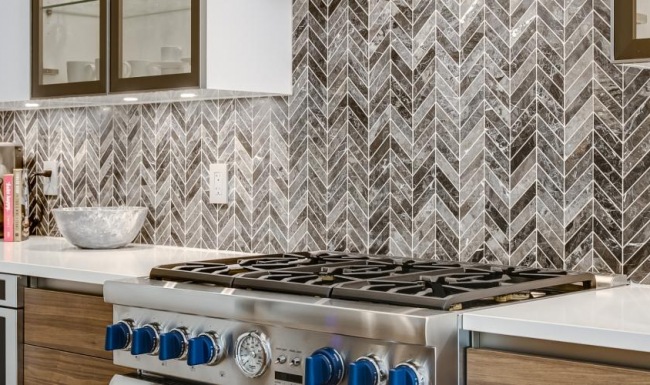 Beautiful kitchens with designer finishes a kitchen with a stove and cups