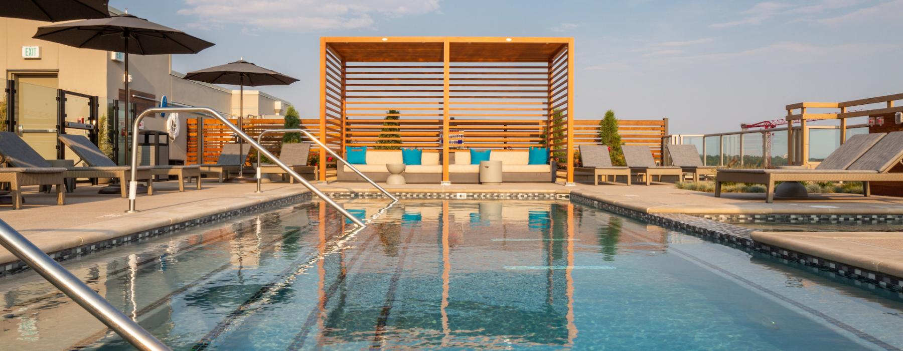 Four-seasons heated pool with daybeds and cabanas