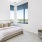 a bedroom with a bed and a chair