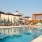 a pool with a deck and chairs by it